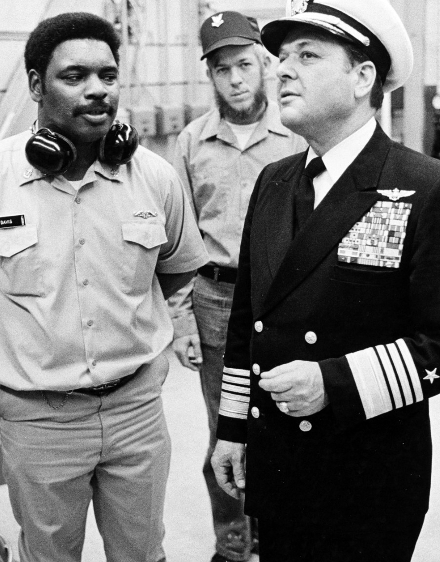 Admiral James L. Holloway, III, USN, Chief of Naval Operations (right). Receives a briefing from Chief Machinist's Mate Lilton W. Davis concerning the Diesel Laboratory at the Fleet Ballistic Missile Submarine Training Center, Charleston, South C...