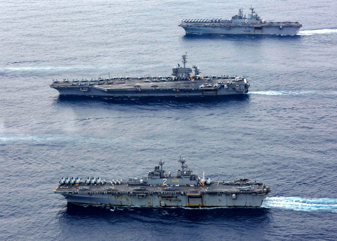 PHILIPPINE SEA (Feb. 7, 2022) The America-class amphibious assault ship USS America (LHA 6), the Nimitz-class aircraft carrier USS Abraham Lincoln (CVN 72) and the Wasp-class amphibious assault ship USS Essex (LHD 2) sail in formation in the Phil...