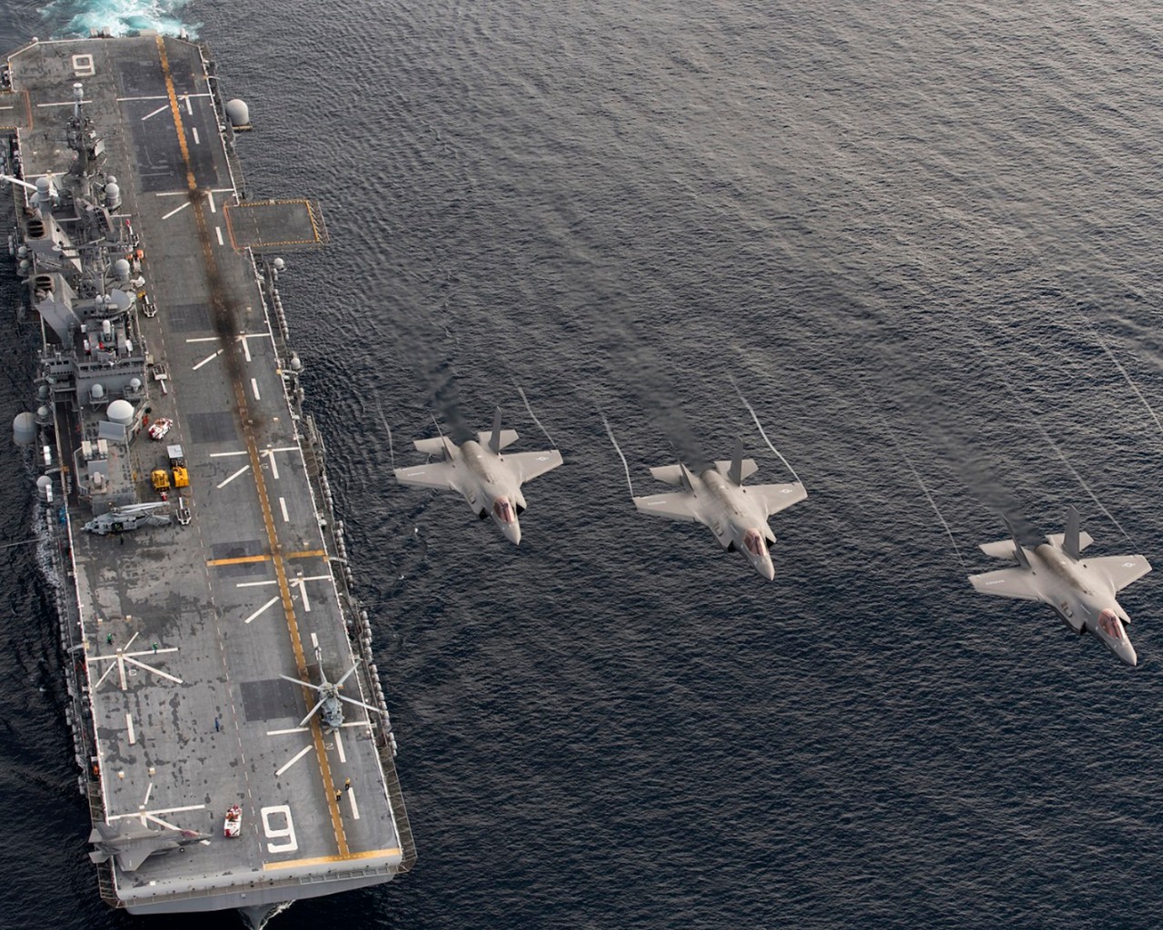 161120-N-VT045-0001 PACIFIC OCEAN (Nov. 19:: 2016) Four F-35B Lightning II aircraft perform a flyover above the amphibious assault ship USS America (LHA 6) during the Lightning Carrier Proof of Concept Demonstration. The F-35B will eventually rep...