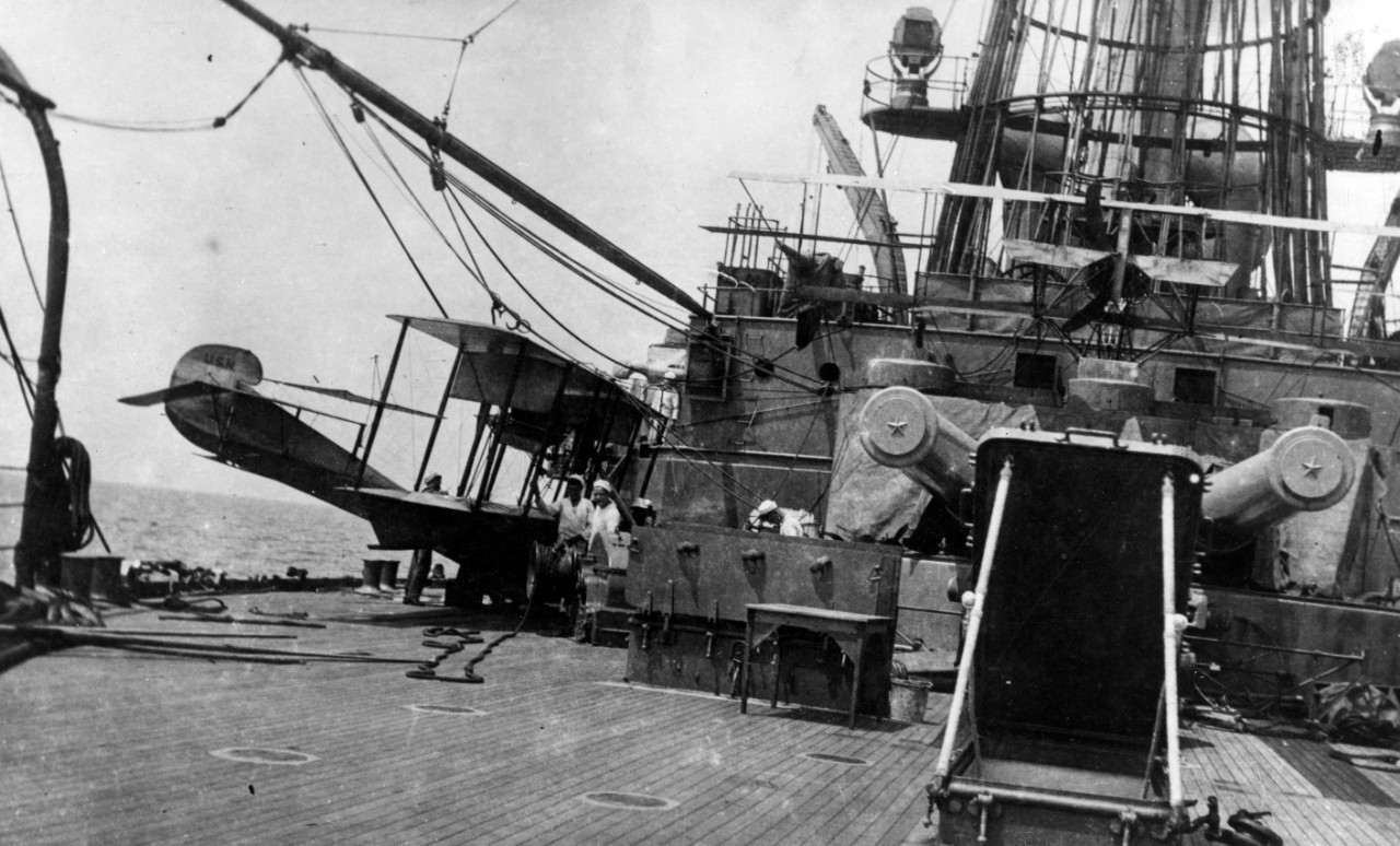 View of the battleship’s afterdeck with planes visible. 