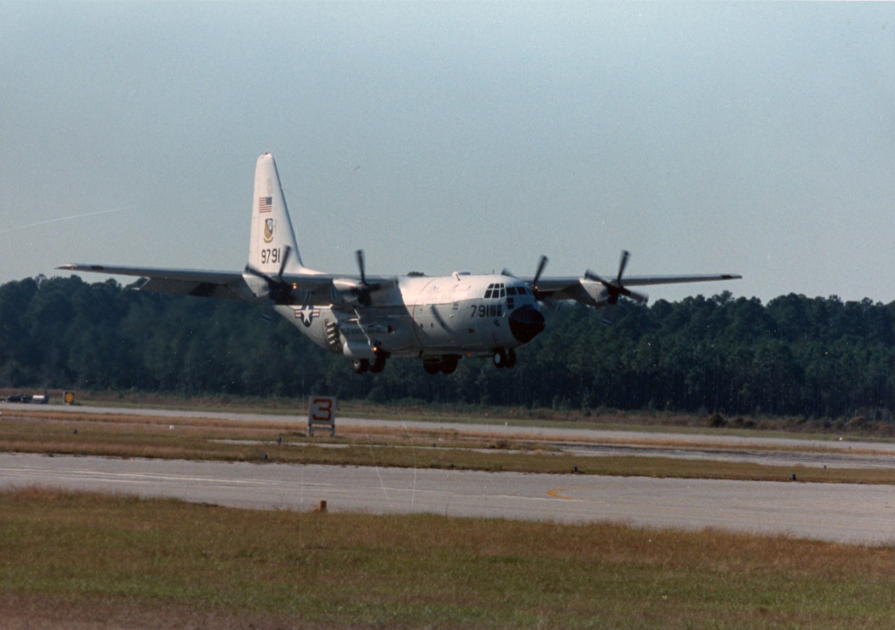 Naval Air Station, Pensacola, FL - Fat Albert, the C-130 Hercules aircraft used to transport equipment, fuel and the highly specialized maintenance crew for the Blue Angels Flight Demonstration Squadron, lands during the station's annual open house and air show. November 11, 1989. 