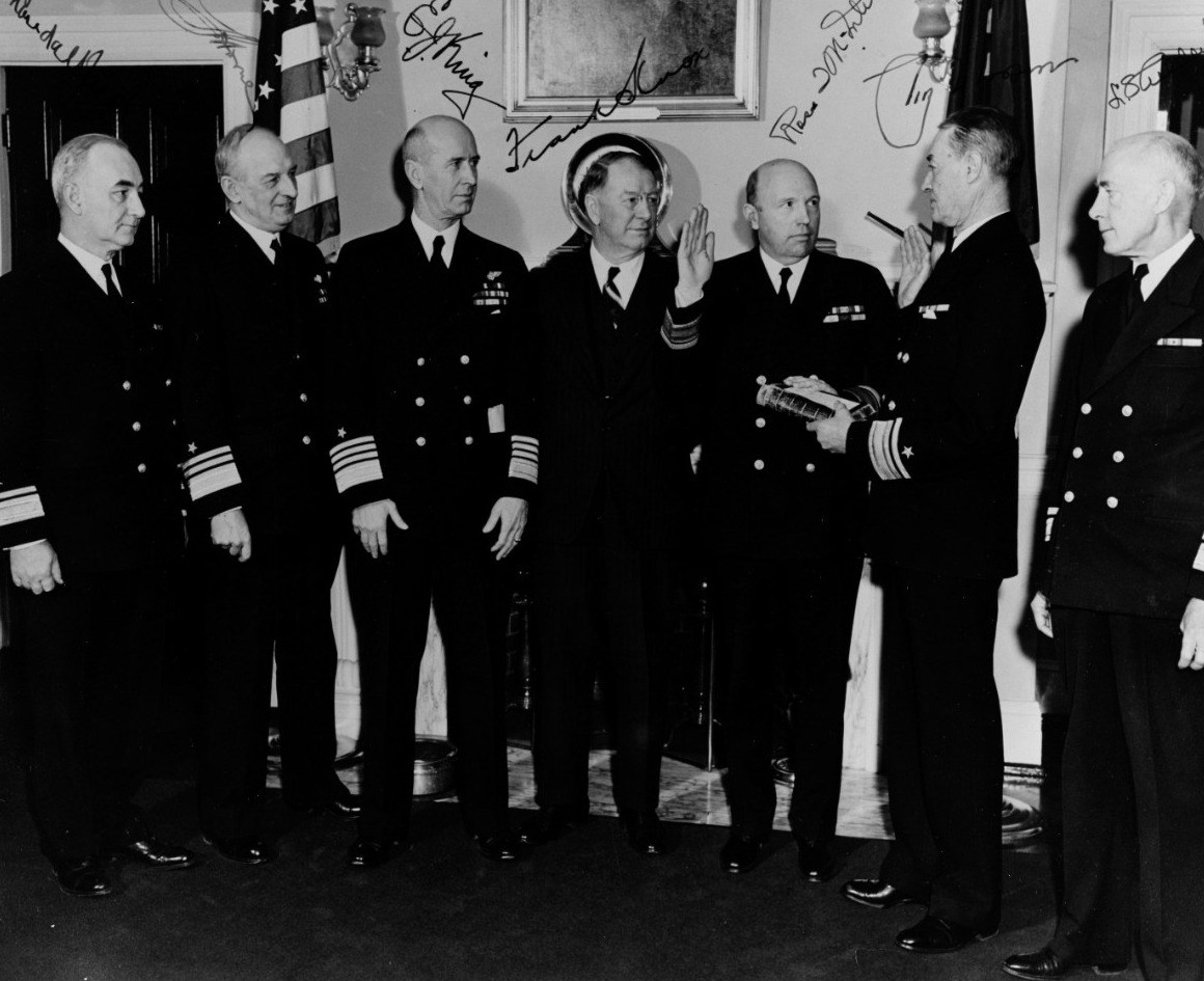 official photo of Mcintire taking his oath of office surrounded by other uniformed people