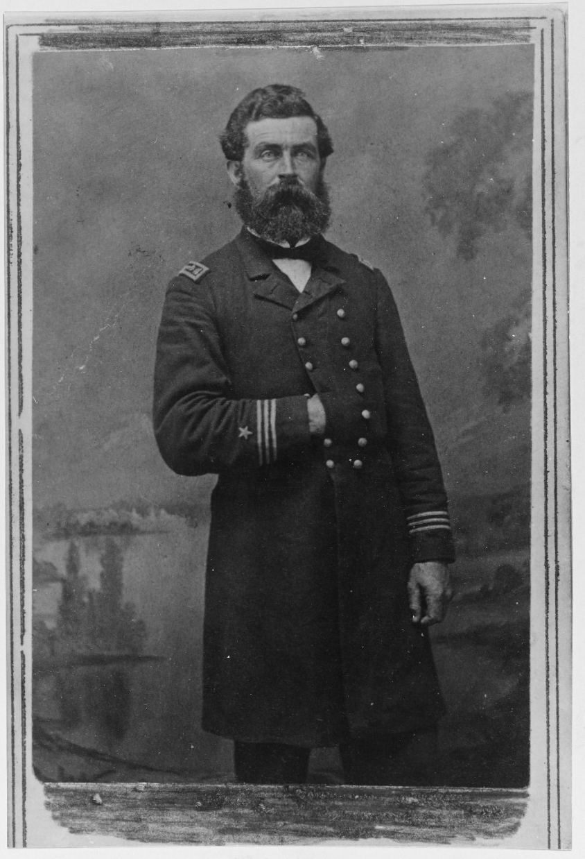 black and white photo of bearded man posing for a photo