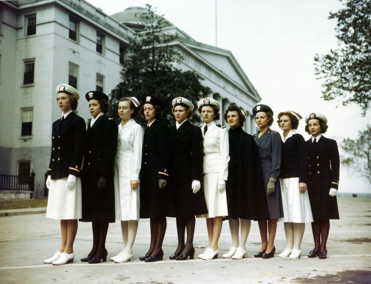 Ten women in ten different Navy uniforms line up horizontally
