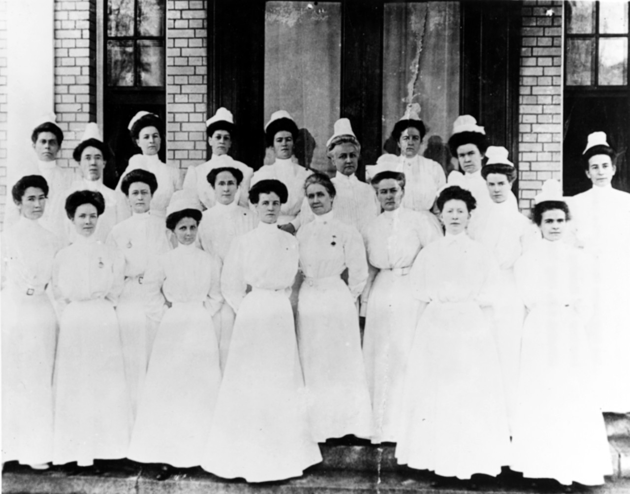 The Sacred Twenty pose in white nursing uniform