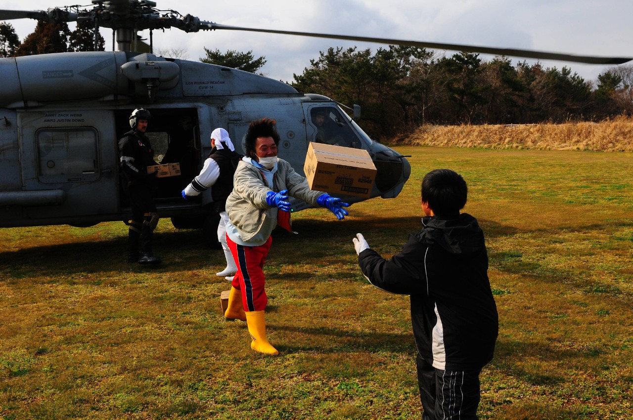Japanese citizens unload humanitarian assistance supplies