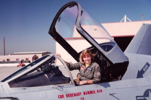 A female pilot in the cockpit of her aircraft. 