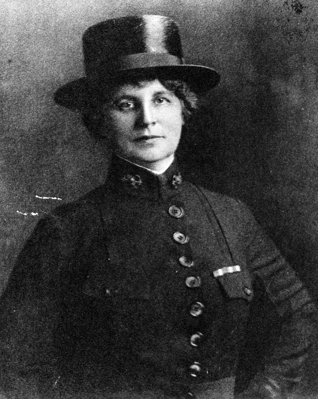 A portrait of a woman wearing a World War I uniform.