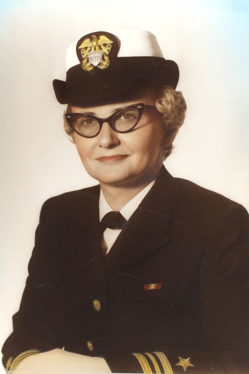 White woman wearing glasses in naval uniform
