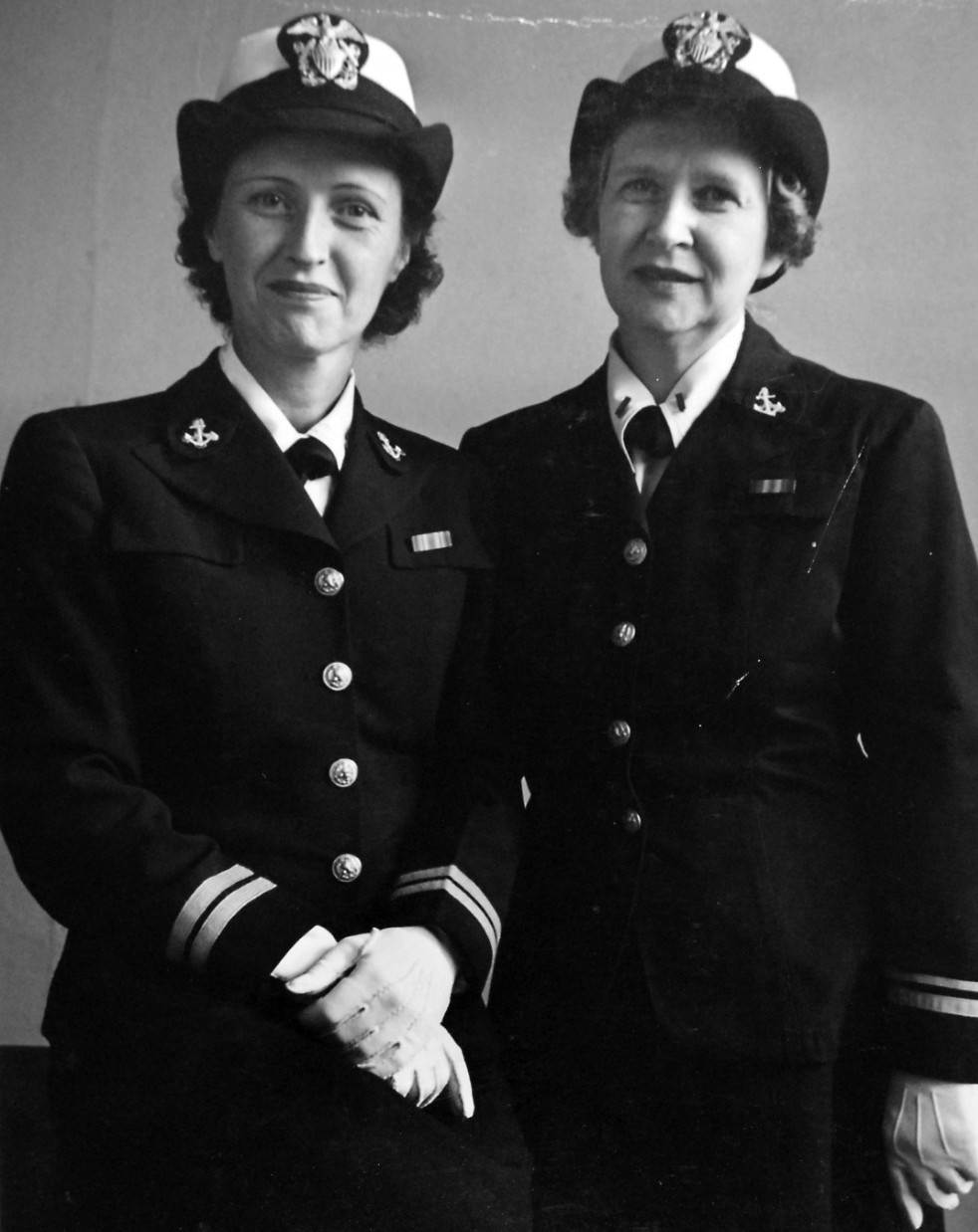 Photo of two female officers in dress blue uniform.