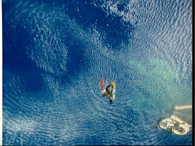 Astronaut Charles Conrad hoisted aboard recovery helicopter