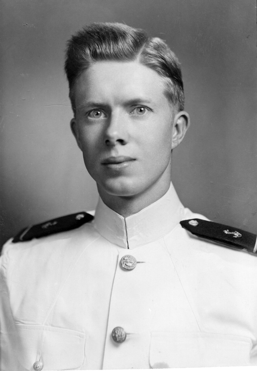 Black and white headshot photograph of a young man in a Navy uniform. 