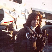 <p>Female aviator in front of a plane on the ground.&nbsp;</p>