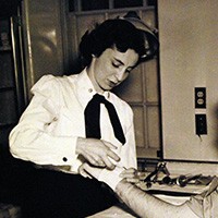 <p>A white woman administering to a patient.&nbsp;</p>