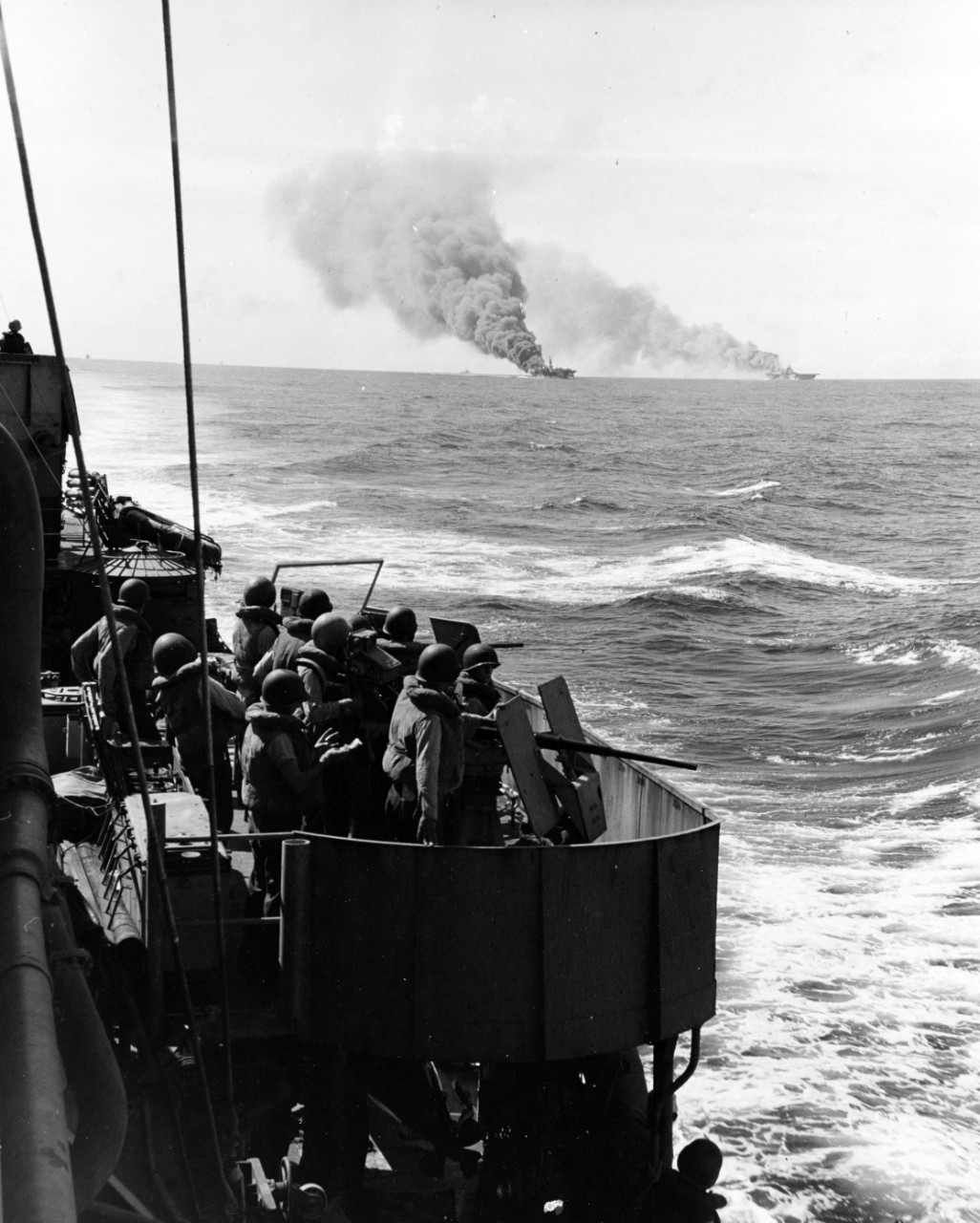 USS Belleau Wood (CVL-24) and USS Franklin (CV-13) on fire