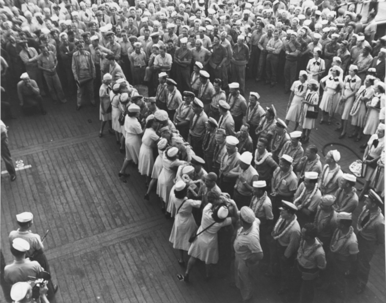WAVES kissed Sailors during a “Back to the States” party on the flight deck of USS Saratoga (CV-3)