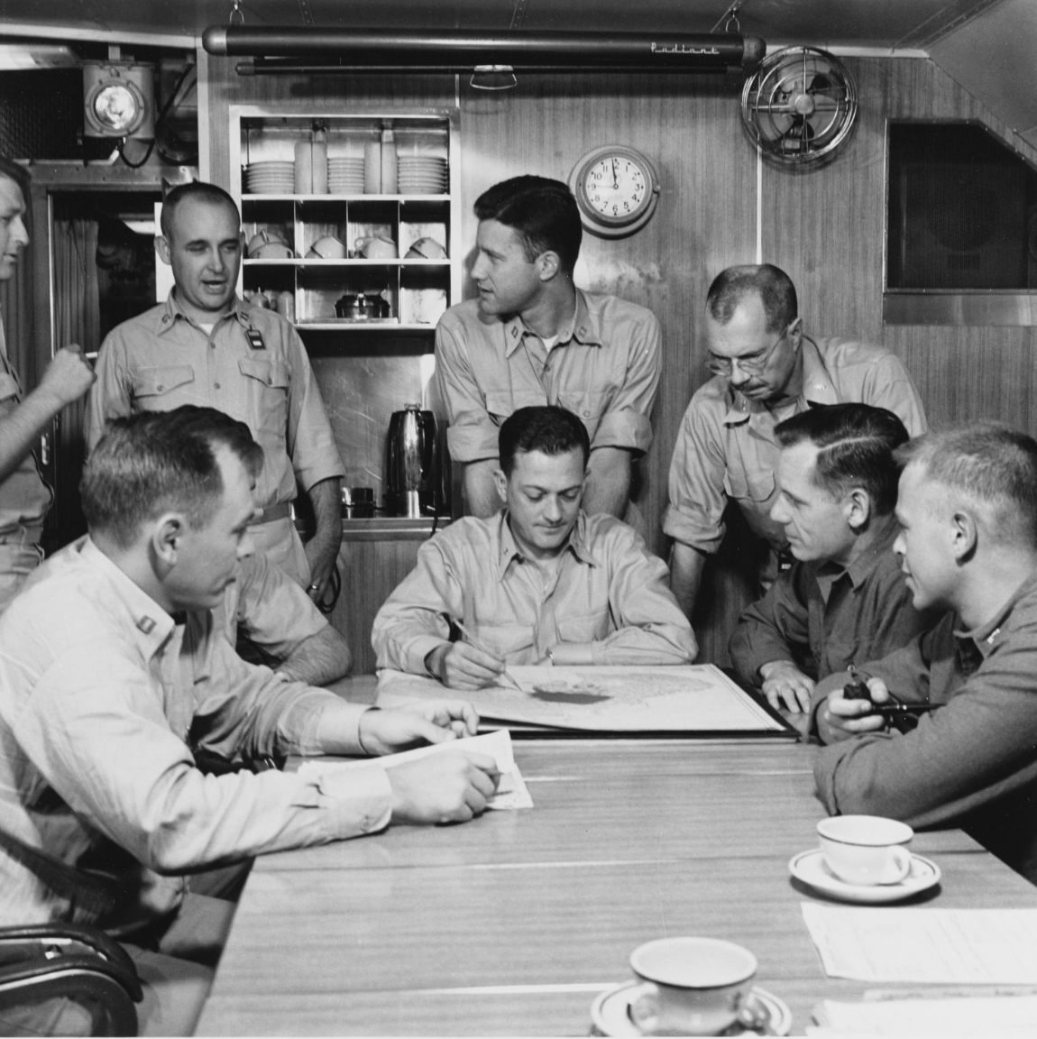 Commander William R. Anderson, commanding officer of USS Nautilus (SSN-571), briefed the ship's officers