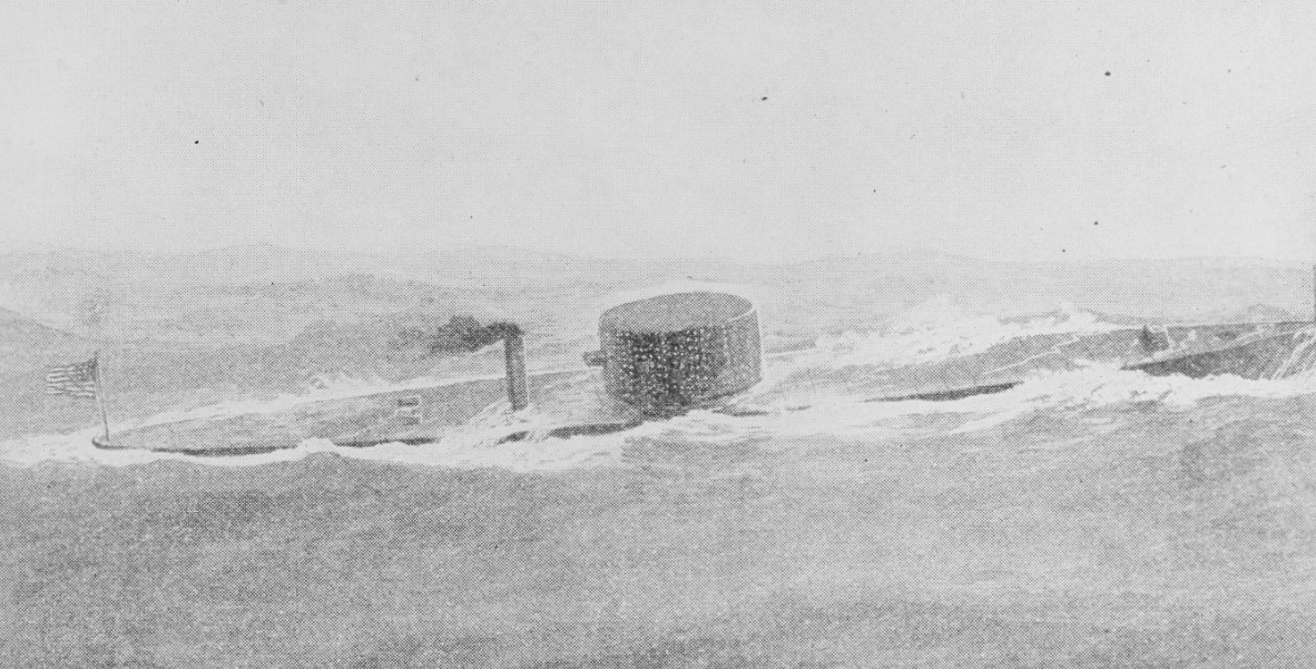 Gray-scale image of ship afloat, with flat deck and turret visible.