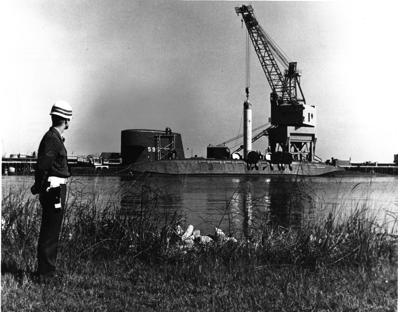 Crane lowers missile into submarine