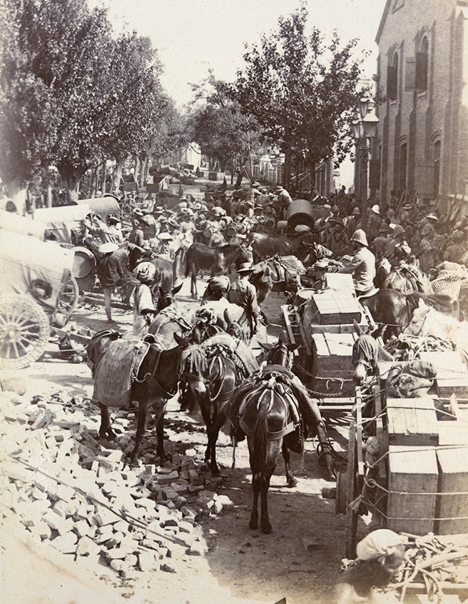 Horse-drawn wagons loaded with supplies.