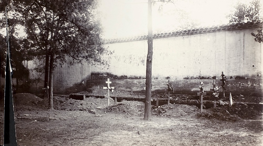 Graveyard with wooden crosses.