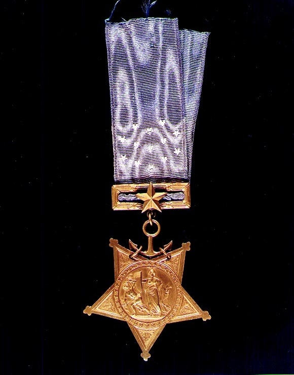 Color image of a gold star attached to a blue ribbon. Clicking on this image directs to a page to download the image.