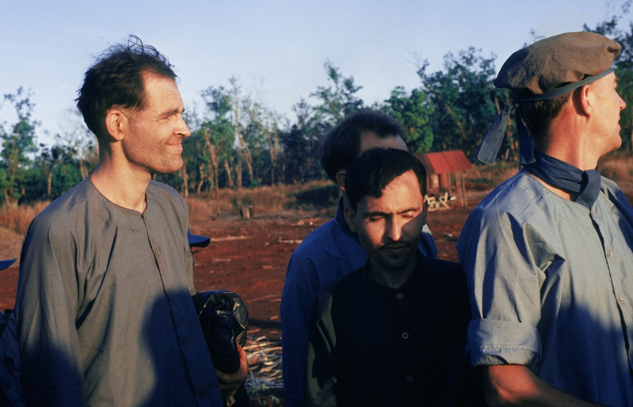 Civilians Douglas Ramsey (center) and James U. Rollins (left) await release by the Viet Cong to American authorities on 12 February 1973.
