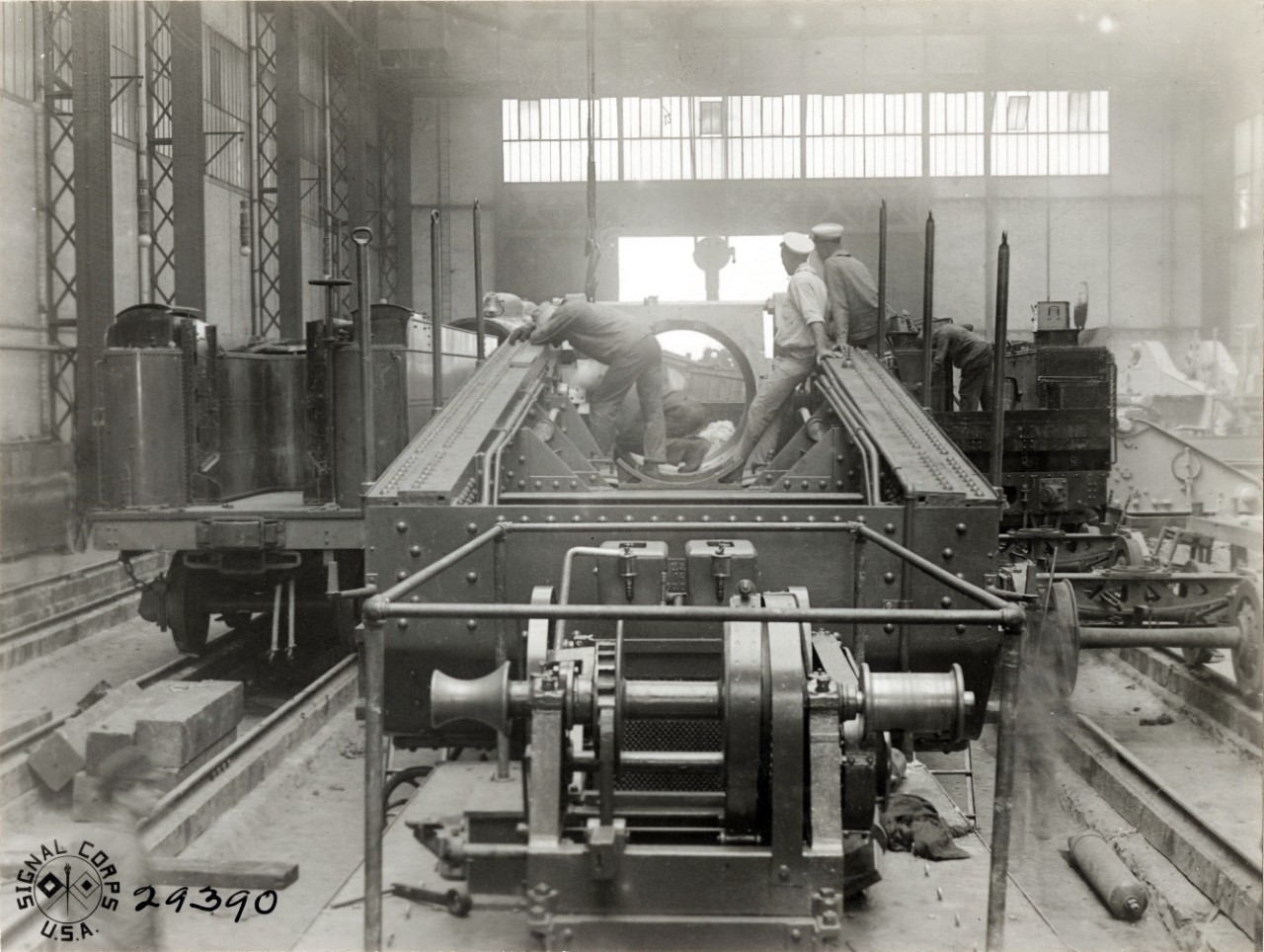 <p>111-SC-29390: 14-Inch Railway Gun. Men greasing the slide to receive the rifle at U.S. Naval Railway Battery, St. Nazaire, France. Photographed by Corporal L.H. McLaughlin, SC, August 1, 1918. U.S. Army Signal Corps Photograph, now in the collections of the National Archives. Archival photograph taken by Mr. James Poynor.</p>
