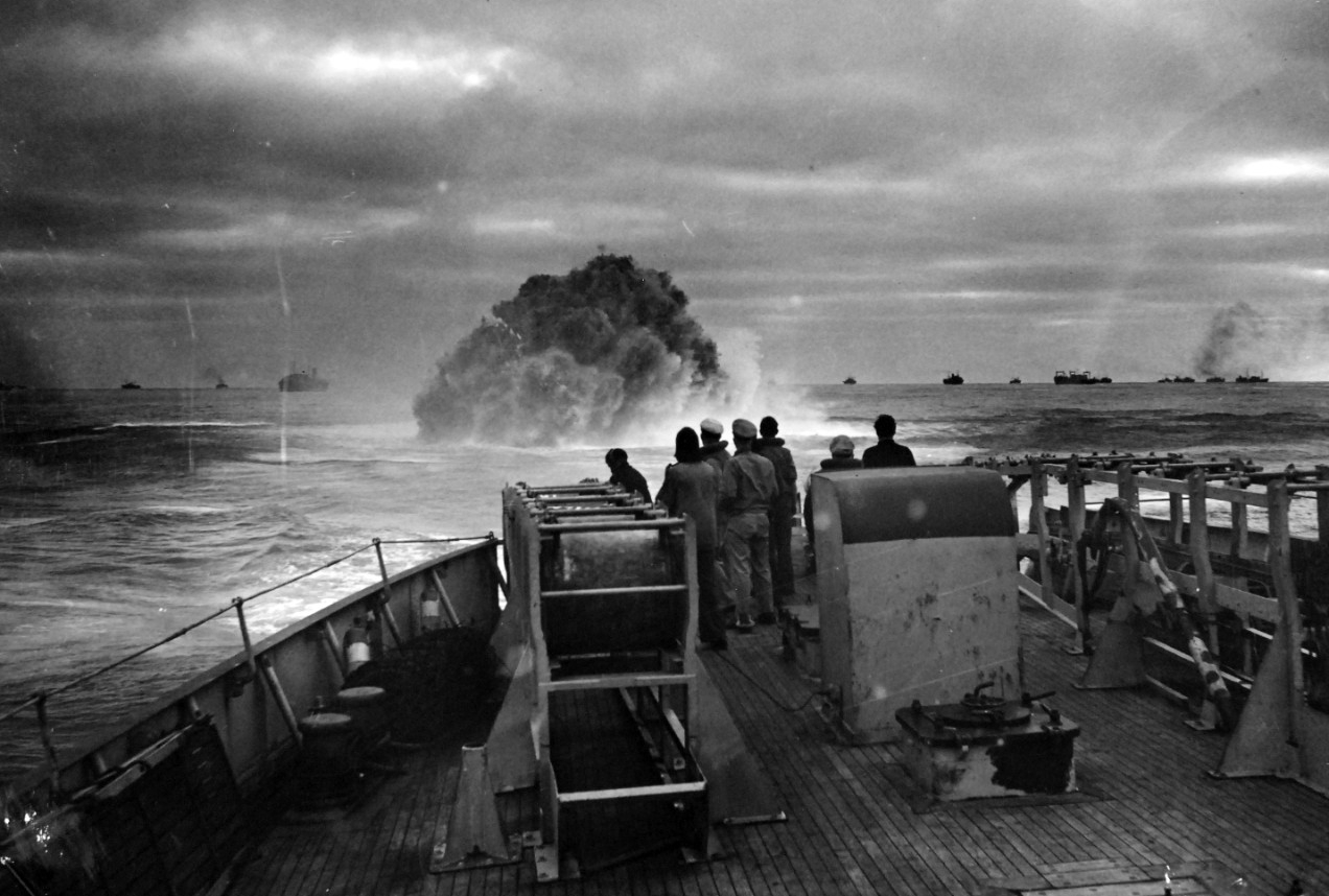 26-G-1517:  Sinking of German submarine U-175, April  1943.   The submarine was sunk off south-west of Ireland by USCGC Spencer (WPG-36) on April 17, 1943.  Official Caption: "COAST GUARD CUTTER SINKS SUB: Coast Guardsmen on the deck of the U.S. Coast Guard Cutter USCGC SPENCER (WPG-36) watch the explosion of a depth charge which blasted a Nazi U-Boat's hope of breaking into the center of a large convoy.  The depth charge tossed from the 327-foot cutter blew the submarine to the surface, where it was engaged by Coast Guardsmen.  Ships of the convoy may be seen in the background."  Date: 17 April 1943.  Official U.S. Coast Guard Photograph, now in the collections of the National Archives.  (2017/09/05).
