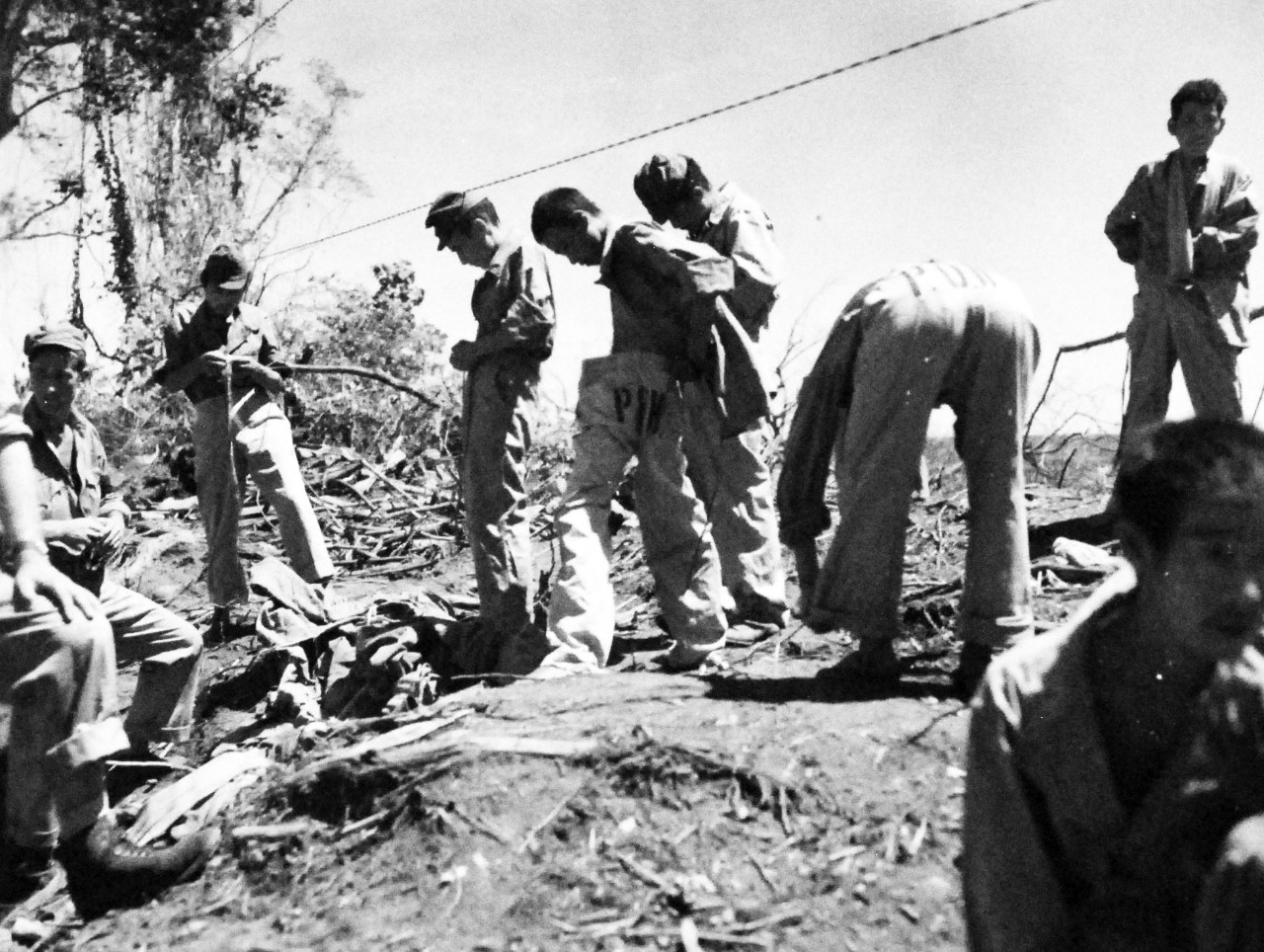 <p>127-GW-971-89059: Battle of Cape Gloucester, New Britain, December 1943-January 1944. Japanese prisoners putting on clean closes. Photographed by Howard, March 1944.&nbsp;</p>
