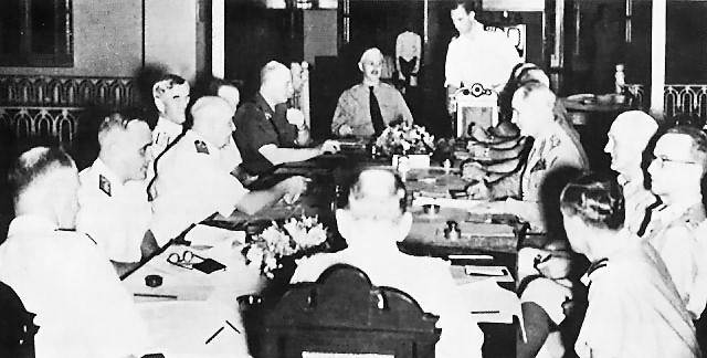 ABDA Command meeting with Gen. Wavell for the first time. Seated, from left: Adms. Layton, Helfrich, and Hart, Gen. ter Poorten, Col. Kengen, Royal Netherlands Army (at head of table), and Gens. Wavell, Brett, and Brereton. (B.M.H., Office Mariti...