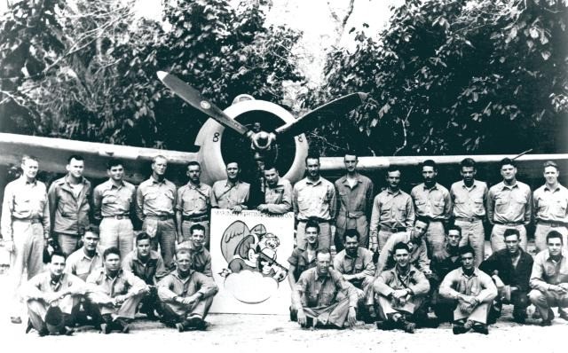 Marines of VMF-212, aka “The Musketeers,” aka “Hell Hounds,” gather for a photo believed to have been taken at Henderson Field, Guadalcanal, September–November 1942. U.S. Marine Corps