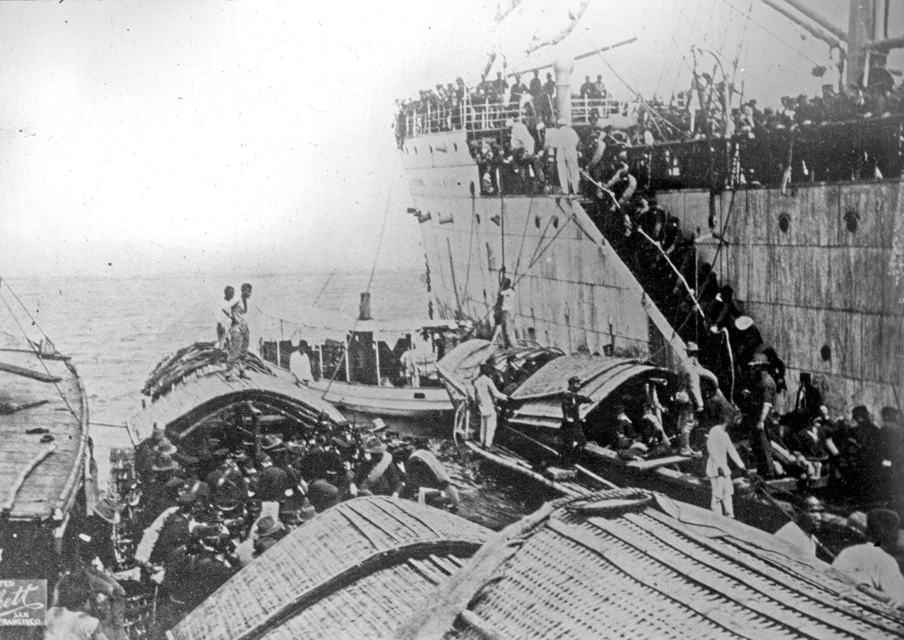 An undated photo show American troops disembarking from a ship onto small boats near Cavite, Phillipines in 1898 or 1899.