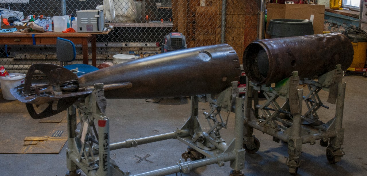 150723-N-TH437-044 WASHINGTON (July 23, 2015) The now fully conserved middle- and after-body sections of Howell Mark I Torpedo No. 24 at the NHHC Archaeology & Conservation Laboratory  on the Washington Navy Yard. Lost from the Iowa (BB 4) during a training exercise and found by a dolphin team from the U.S. Navy Marine Mammal Program off the coast of San Diego, conservators have been conserving and studying the torpedo since May 2013. (U.S. Navy photo by Mass Communication Specialist 2nd Class Eric Lockwood/Released)