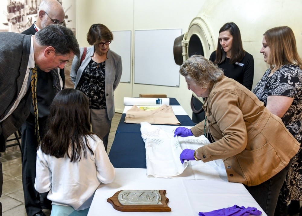 <p>WASHINGTON NAVY YARD (Oct. 15, 2019) Lea Davis, associate registrar for acquisitions at Naval History and Heritage Command (NHHC), tells vistors at the National Museum of the U.S. Navy about an artifact from USS Scorpion (SSN 589) during a donation ceremony. Naval History and Heritage Command (NHHC) the ceremony to unveil four artifacts from Scorpion, donated by retired Rear Adm. Robert Fountain, former executive officer of the submarine. Fountain received the artifacts from the crew in 1968 on his departure from Scorpion; six months before the submarine was declared “presumed lost.” NHHC, located at the Washington Navy Yard, is responsible for the preservation, analysis, and dissemination of U.S. naval history and heritage. (U.S. Navy photo by Mass Communication Specialist 2nd Class (SW/AW) Mutis A. Capizzi/Released)</p>