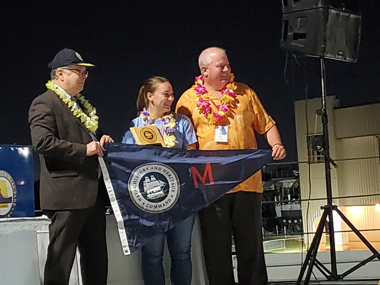 <p>MOBILE, Ala. (Sept. 25, 2021) Naval History and Heritage Command (NHHC) Director Samuel J. Cox, left, and NHHC Navy Museums Division Director Dave Adams present the “Maintenance Excellence Award” to Shanna Schuster, a representative for Destroyer Escort Historical Museum USS <i>Slater</i> (DE 766). NHHC presented the 2021 Museum Excellence Awards at the annual Historic Naval Ships Association Conference hosted at USS Alabama Battleship Memorial Park. (U.S. Navy photo/Released)</p>