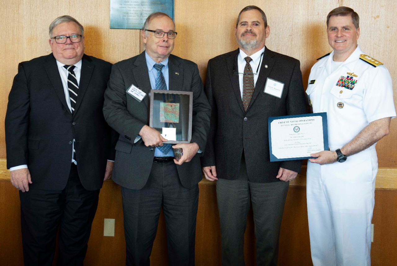 Rear Adm. Fred Kacher, acting Superintendent for the Naval Academy; Naval History and Heritage Command Director, retired Rear. Adm. Sam Cox, and Chief Executive Officer of the U.S. Naval Institute, retired Vice Adm. Peter H. Daly present awards t...
