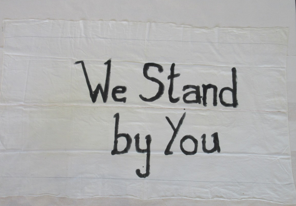 "We Stand by You" banner