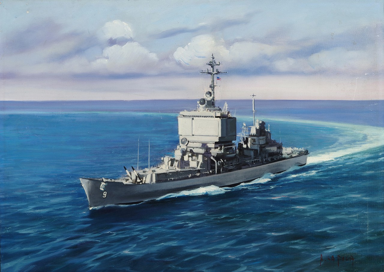 A navy ship on a calm sea making a turn