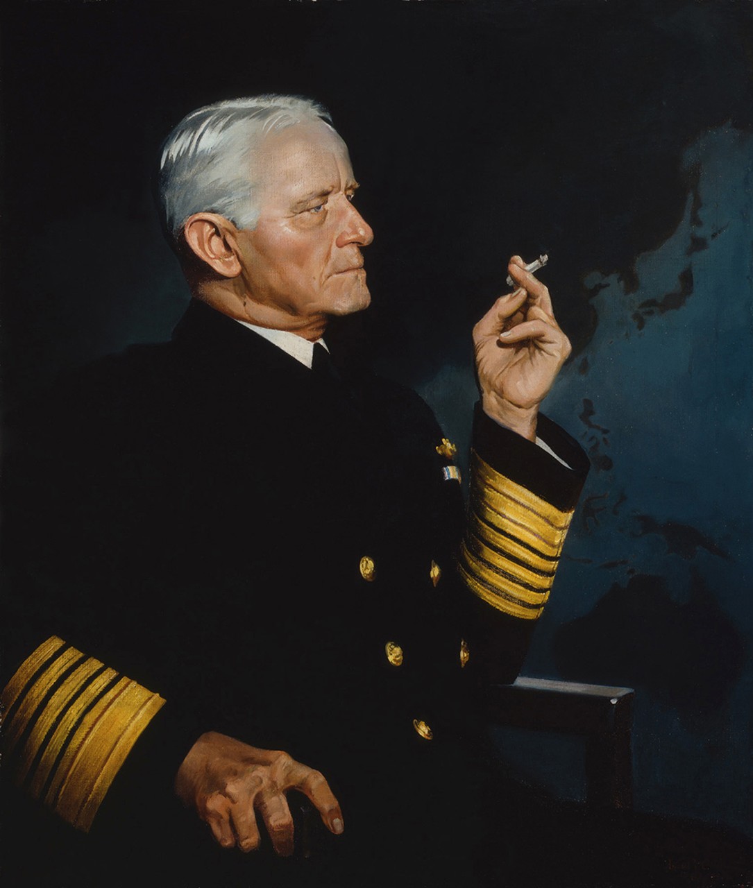 Admiral Chester W. Nimitz is seated smoking a cigarette and wearing his dress blues