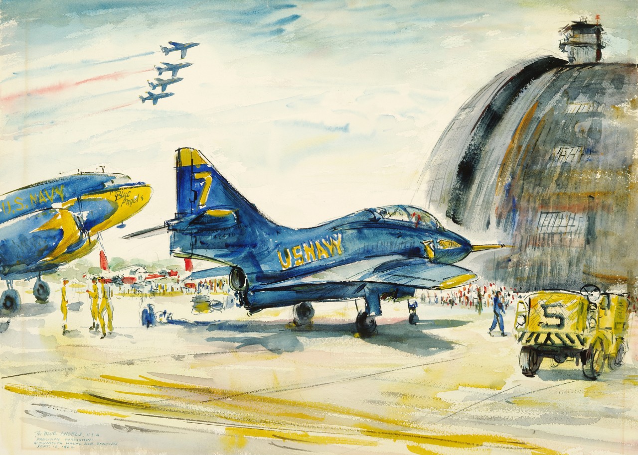 Two Blue Angels planes on the tarmac with people looking at them. In the background a hanger and four blue angels fly overhead.