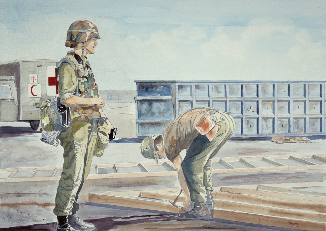 Two Seabees work on a project in the desert