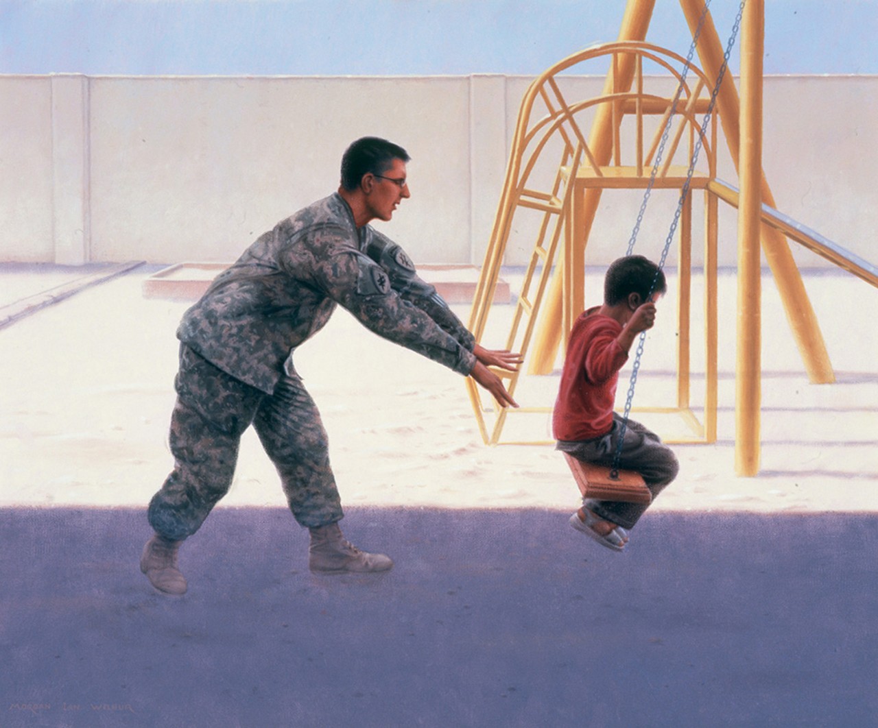 A man in uniform pushes a little boy on a playground swing