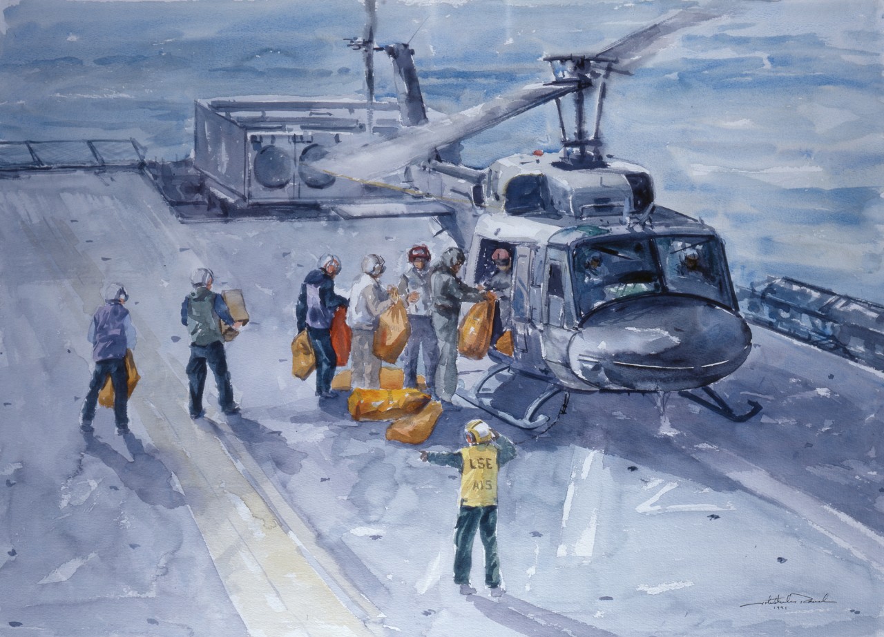 On the deck of a ship sailors are loading a helicopter with bags of mail