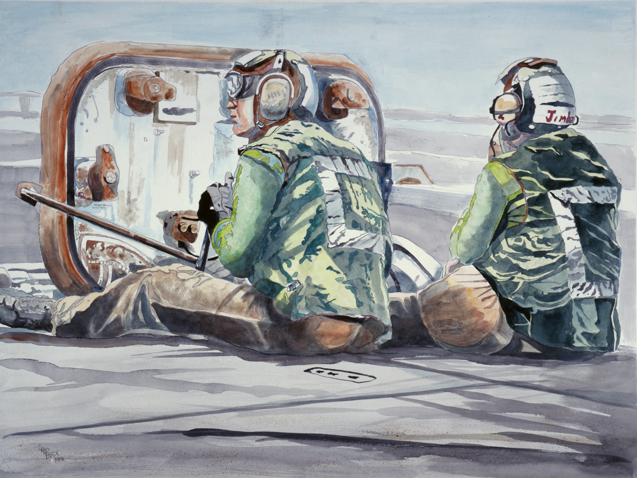 Two crewmen sit on the deck during flight operations