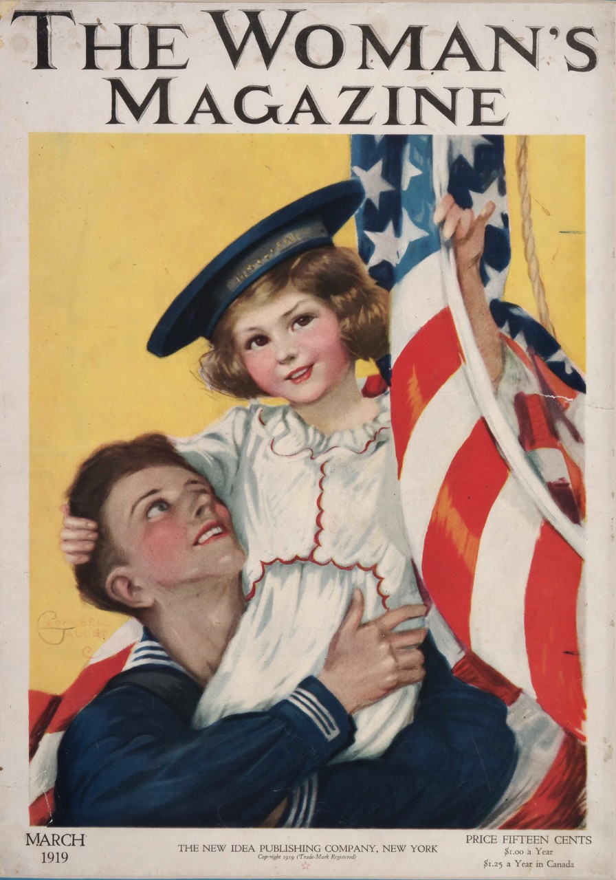A man holds a little girl on his shoulder she is holding onto a flag