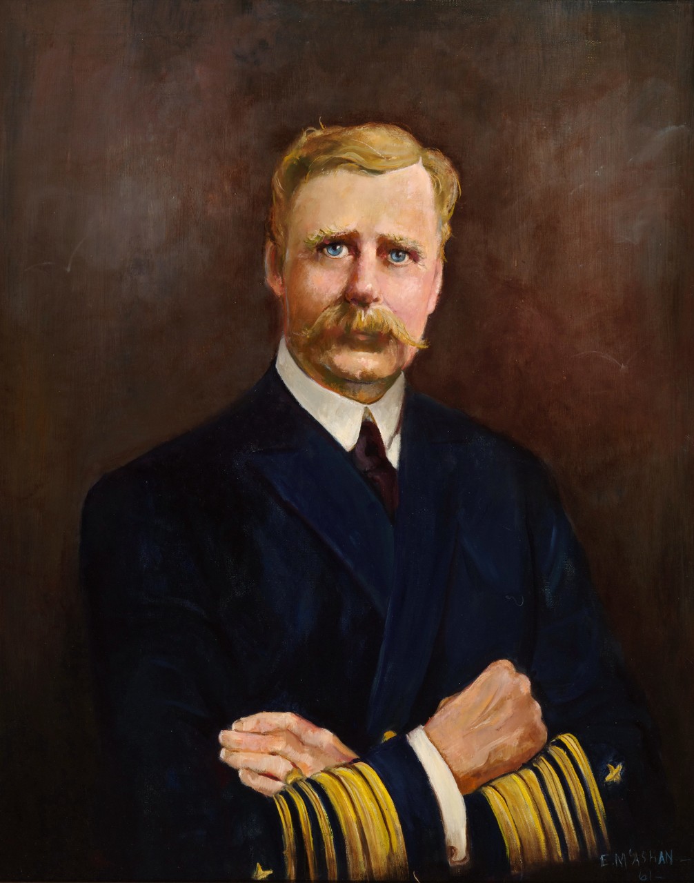Portrait from the waist up of a naval officer, his arms are folded