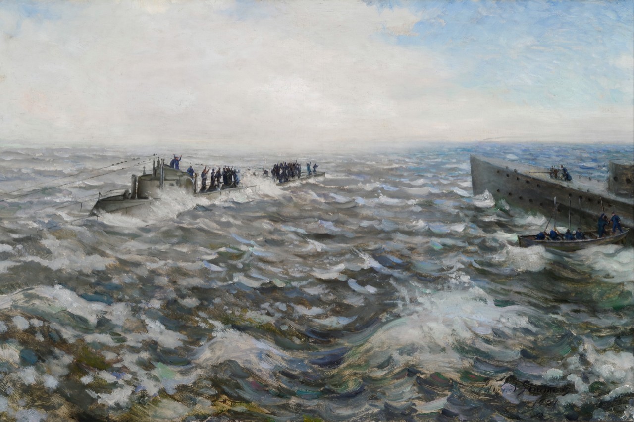 The crew of a submarine is gathered on the deck in rough seas, another ship off to right is sending a boat to the submarine