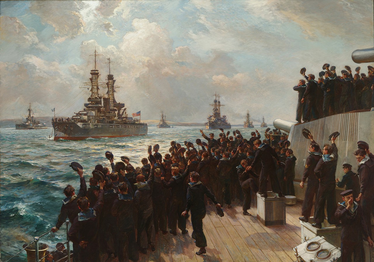 Sailors on the deck of a ship wave their hats at a fleet of ships