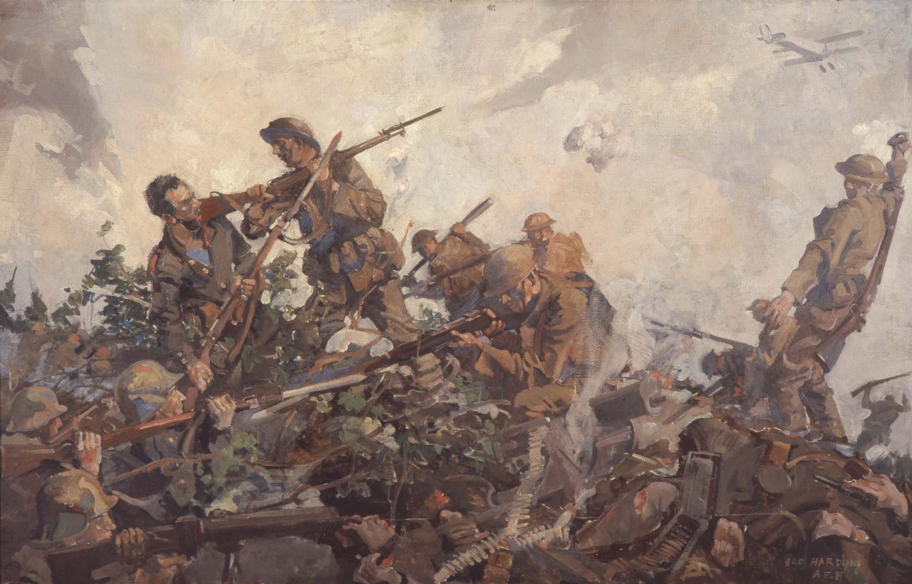 Soldiers fighting on top of a hill.  One marine is hitting a soldier with the butt of his rifle